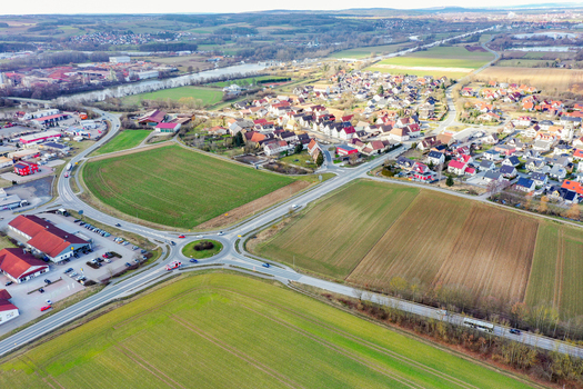 Aerial view of the town of Forchheim featuring a traffic roundabout residential houses and green agricultural fields Forchheim Bavaria Germany. Aerial view of the town of Forchheim featuring a traffic roundabout residential houses and green agricultural fields Forchheim Bavaria Germany.