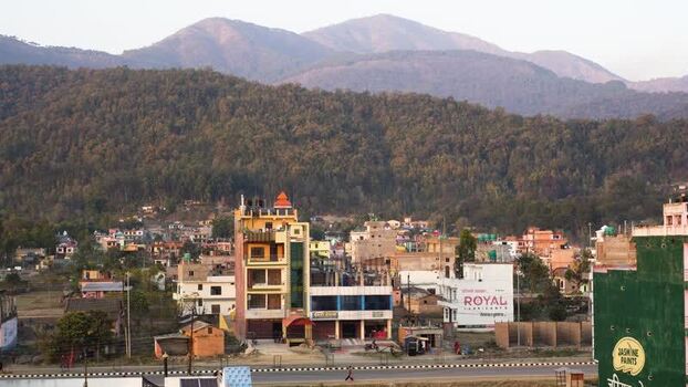 View of colorful buildings and forested hills Nepal.