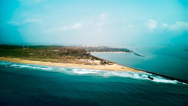 Aerial view of Tarkwa Bay Beach with its sandy coastline turquoise waters and a long breakwater extending into the Atlantic Ocean in Lagos Lagos Nigeria. Aerial view of Tarkwa Bay Beach with its sandy coastline turquoise waters and a long breakwater extending into the Atlantic Ocean in Lagos Lagos Nigeria.