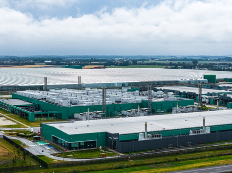 Aerial view of Agriport A7 industrial complex featuring large greenhouses and modern warehouse facilities under a cloudy sky in Middenmeer Noord Holland Netherlands. Aerial view of Agriport A7 industrial complex featuring large greenhouses and modern warehouse facilities under a cloudy sky in Middenmeer Noord Holland Netherlands.