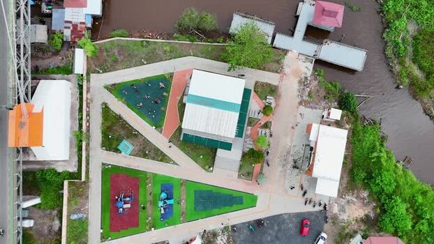 Aerial view of Urban Park with playgrounds and riverfront Indonesia.