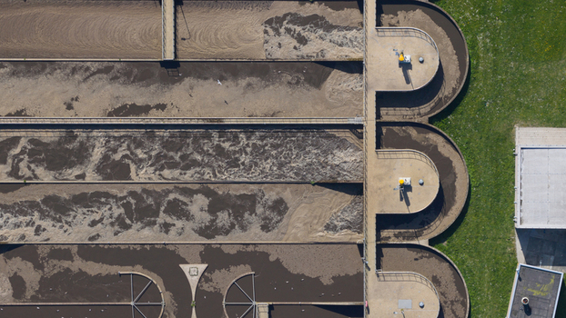 Aerial view of RWZI Geestmerambacht wastewater treatment plant with aeration tanks and concrete walkways Netherlands. Aerial view of RWZI Geestmerambacht wastewater treatment plant with aeration tanks and concrete walkways Netherlands.