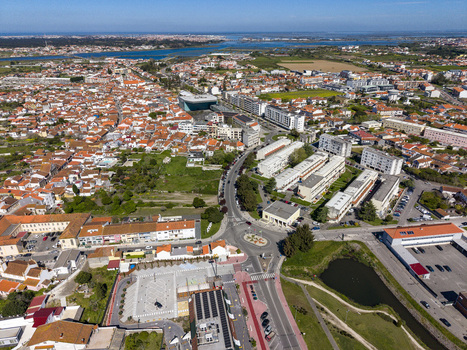Aerial view of terracotta rooftops contrasting with modern buildings bisected by winding roads near the water Aveiro Portugal. Aerial view of terracotta rooftops contrasting with modern buildings bisected by winding roads near the water Aveiro Portugal.