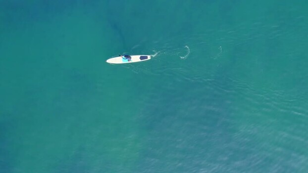 Aerial view of person on a paddleboard at Circuito de Playas Peru. Aerial view of person on a paddleboard at Circuito de Playas Peru.