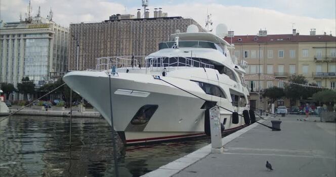 View of a luxury white yacht moored at the harbor in Rijeka Croatia. View of a luxury white yacht moored at the harbor in Rijeka Croatia.