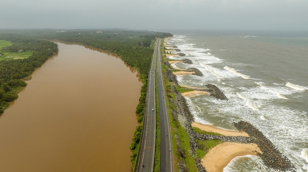 Aerial view of Maravanthe beach with a highway separating the Souparnika river and the Arabian Sea in Maravanthe Karnataka India. Aerial view of Maravanthe beach with a highway separating the Souparnika river and the Arabian Sea in Maravanthe Karnataka India.