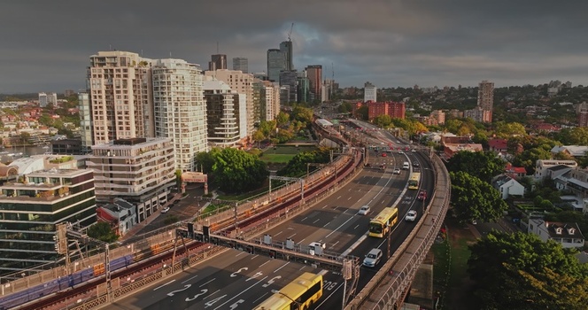 Aerial view of the Sydney skyline and Cahill Expressway with traffic moving along the road surrounded by modern high rise buildings in Sydney New South Wales Australia. Aerial view of the Sydney skyline and Cahill Expressway with traffic moving along the road surrounded by modern high rise buildings in Sydney New South Wales Australia.