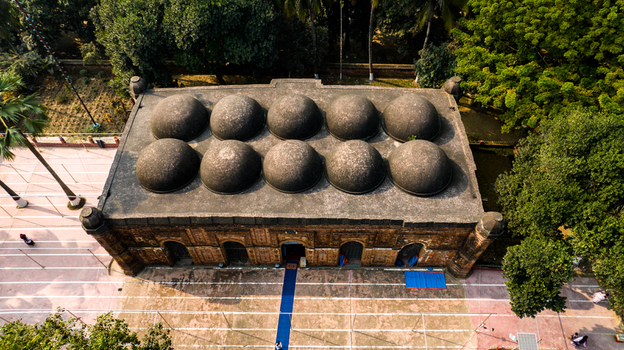 Aerial view of Bagha Shahi Mosque with its distinctive ten domes and terracotta brick architecture surrounded by lush trees Rajshahi Rajshahi Division Bangladesh.