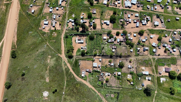 Aerial view of the rural settlement of Alma with small houses and fenced garden plots along dirt roads Waterberg District Municipality Limpopo South Africa. Aerial view of the rural settlement of Alma with small houses and fenced garden plots along dirt roads Waterberg District Municipality Limpopo South Africa.