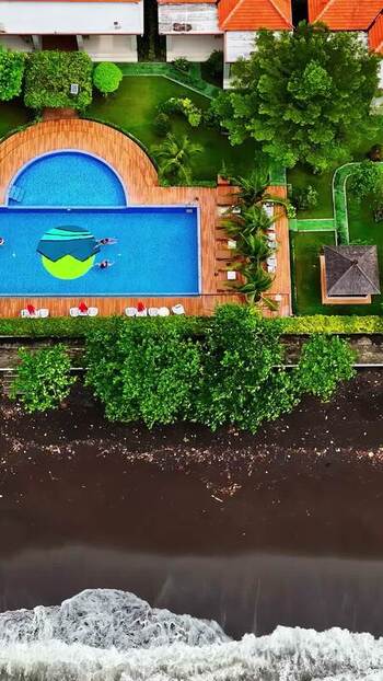 Aerial view of resort pool near beach in Bali Indonesia.