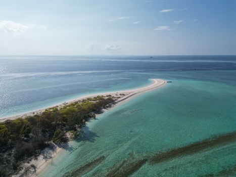 Aerial view of the sandbar of Pulau Ndaa surrounded by turquoise water and coral reefs in Tomia South East Sulawesi Indonesia.