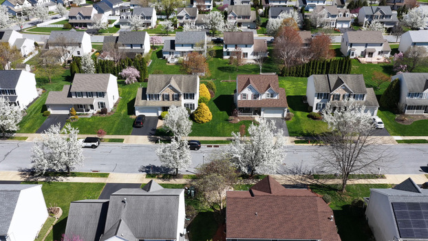 Aerial view of a suburban neighborhood with blooming spring trees and residential houses in Lititz Pennsylvania United States.