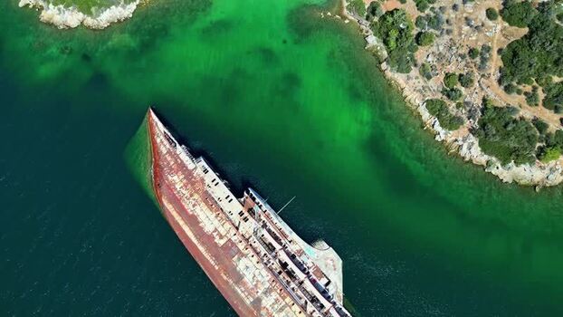 Aerial view of shipwreck in clear green water Greece.