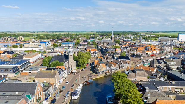 Aerial view of the historic town of Lemmer featuring a canal with boats traditional Dutch architecture and a church tower in Lemmer Friesland Netherlands. Aerial view of the historic town of Lemmer featuring a canal with boats traditional Dutch architecture and a church tower in Lemmer Friesland Netherlands.