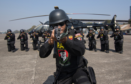 Dhaka Bangladesh 19 January 2017 View of Rapid Action Battalion RAB special force members in tactical gear aiming rifles with a black helicopter at RAB Headquarters. Dhaka Bangladesh 19 January 2017 View of Rapid Action Battalion RAB special force members in tactical gear aiming rifles with a black helicopter at RAB Headquarters.