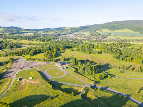Aerial view of the Cross country ski area Vesec featuring winding tracks lush green hills and surrounding forests in Liberec Liberec Region Czechia. Aerial view of the Cross country ski area Vesec featuring winding tracks lush green hills and surrounding forests in Liberec Liberec Region Czechia.