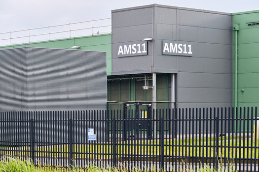 Middenmeer Netherlands 17 May 2026 View of the Microsoft AMS11 datacenter facility with its modern grey and green facade behind a black security fence.