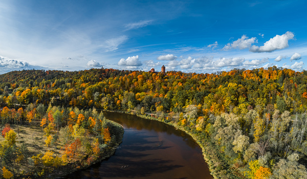 Aerial view of Turaida Castle surrounded by vibrant autumn forest and the winding Gauja River in Sigulda Sigulda Municipality Latvia. Aerial view of Turaida Castle surrounded by vibrant autumn forest and the winding Gauja River in Sigulda Sigulda Municipality Latvia.