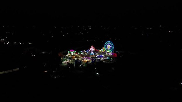 Aerial view of illuminated fairground rides in Mataram Indonesia.