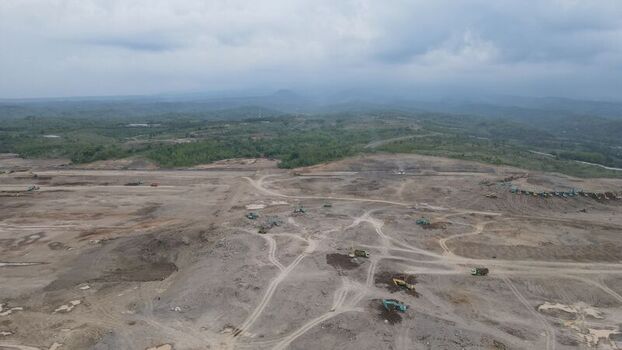 Aerial view of the Dhoho International Airport construction site with heavy machinery earthworks and surrounding hills in Kecamatan Grogol Jawa Timur Indonesia. Aerial view of the Dhoho International Airport construction site with heavy machinery earthworks and surrounding hills in Kecamatan Grogol Jawa Timur Indonesia.