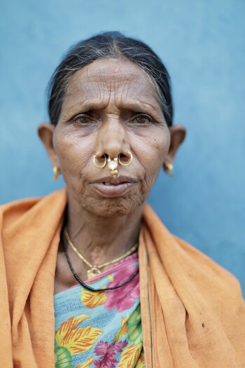 Odisha India 26 March 2026 View of an elderly woman with a nose ring and traditional clothing against a striking blue wall highlighting the textures of age and culture. Odisha India 26 March 2026 View of an elderly woman with a nose ring and traditional clothing against a striking blue wall highlighting the textures of age and culture.