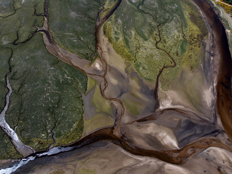 Aerial view of the intricate water channels and sandy banks of Findhorn Bay surrounded by green marshland Findhorn Scotland United Kingdom. Aerial view of the intricate water channels and sandy banks of Findhorn Bay surrounded by green marshland Findhorn Scotland United Kingdom.