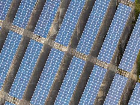 Aerial view of the solar farm at the former Military Airfield Preschen featuring rows of solar panels installed over the historic runway and taxiway in Neisse Malxetal Brandenburg Germany. Aerial view of the solar farm at the former Military Airfield Preschen featuring rows of solar panels installed over the historic runway and taxiway in Neisse Malxetal Brandenburg Germany.