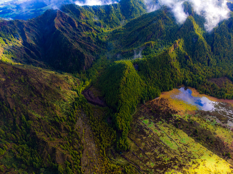 Aerial view of Lagoa do Fogo surrounded by lush green volcanic mountains and misty peaks in Agua de Alto Azores Portugal. Aerial view of Lagoa do Fogo surrounded by lush green volcanic mountains and misty peaks in Agua de Alto Azores Portugal.