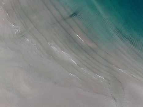 Aerial view of the sandy shoreline of Gruinard Bay with gentle waves and turquoise water ripples Gruinard Scotland United Kingdom. Aerial view of the sandy shoreline of Gruinard Bay with gentle waves and turquoise water ripples Gruinard Scotland United Kingdom.