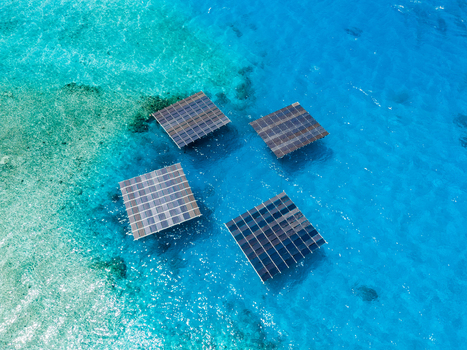 Aerial view of SolarSea floating solar power plant by Swimsol with four square solar panels on turquoise ocean water in Dharavandhoo Baa Atoll Maldives. Aerial view of SolarSea floating solar power plant by Swimsol with four square solar panels on turquoise ocean water in Dharavandhoo Baa Atoll Maldives.