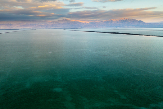 Aerial view of the vast expanse of the Dead Sea reflects the pastel hues of the dawn sky over distant mountains Arad Israel. Aerial view of the vast expanse of the Dead Sea reflects the pastel hues of the dawn sky over distant mountains Arad Israel.
