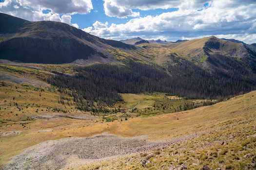 View of San Luis Peak and the rugged mountainous landscape with alpine meadows rocky slopes and a dramatic sky in Creede Colorado United States. View of San Luis Peak and the rugged mountainous landscape with alpine meadows rocky slopes and a dramatic sky in Creede Colorado United States.