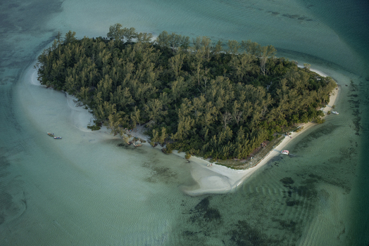 Aerial view of a small tropical island with dense forest and white sandy beaches surrounded by clear turquoise water in Rio de Janeiro Rio de Janeiro Brazil. Aerial view of a small tropical island with dense forest and white sandy beaches surrounded by clear turquoise water in Rio de Janeiro Rio de Janeiro Brazil.