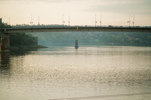 View of the Varadin Bridge spanning the Danube River with calm water and soft light in Novi Sad Vojvodina Serbia. View of the Varadin Bridge spanning the Danube River with calm water and soft light in Novi Sad Vojvodina Serbia.