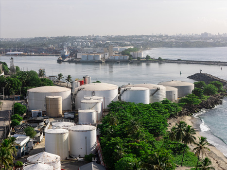 Aerial view of the industrial storage tanks and port facilities situated along the coastline in Bajos de Haina San Cristobal Province Dominican Republic.
