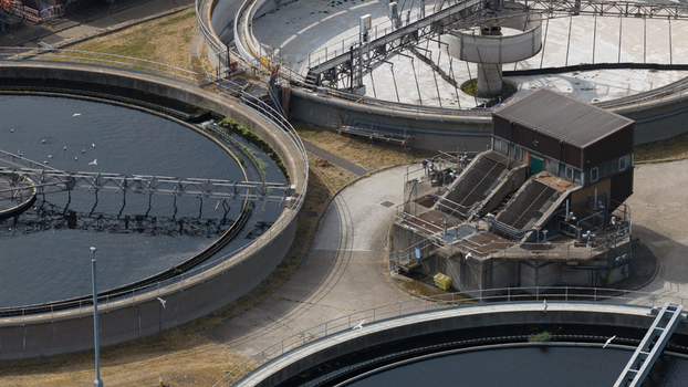 Aerial view of the M Group Water treatment facility featuring large circular sedimentation tanks and industrial infrastructure in Dartford England United Kingdom.