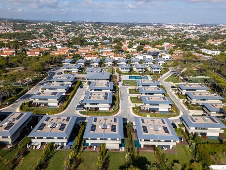 Aerial view of Quinta da Marinha residential complex featuring modern houses with solar panels private swimming pools and manicured lawns in Cascais Lisbon Portugal. Aerial view of Quinta da Marinha residential complex featuring modern houses with solar panels private swimming pools and manicured lawns in Cascais Lisbon Portugal.