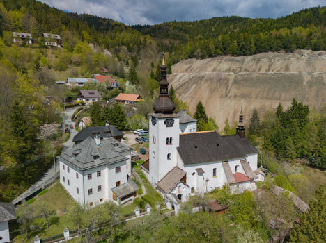 Aerial view of the historic Church of the Conversion of the Lord and traditional houses in the mountain village of Spania Dolina Banska Bystrica Region Slovakia.