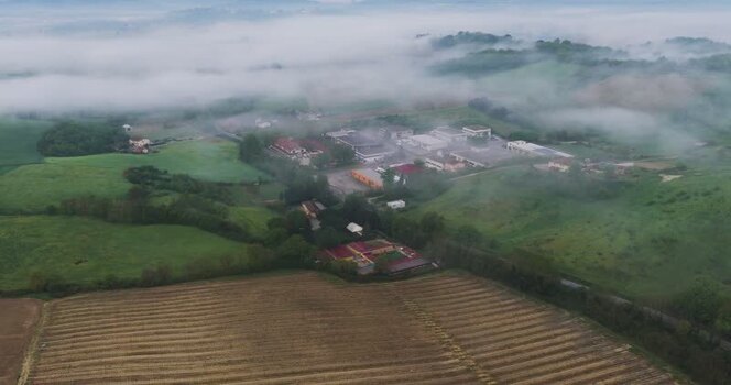 Aerial view of misty hills and buildings in Castelfranco Piandisco Italy. Aerial view of misty hills and buildings in Castelfranco Piandisco Italy.