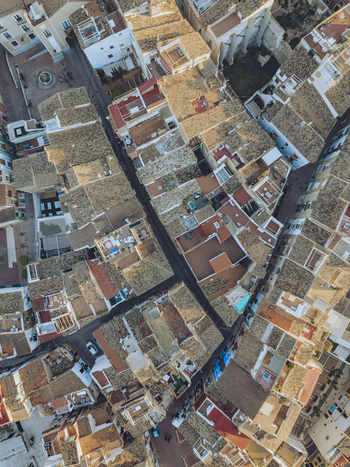 Aerial view of the dense cluster of traditional houses with terracotta rooftops and narrow alleys in the old town of La Vila Joiosa Valencian Community Spain. Aerial view of the dense cluster of traditional houses with terracotta rooftops and narrow alleys in the old town of La Vila Joiosa Valencian Community Spain.