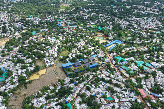 Aerial view of Camp 7 in the Kutupalong expansion sites showing dense clusters of makeshift shelters with tarpaulin roofs and narrow paths in Cox s Bazar District Chittagong Division Bangladesh.