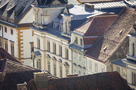 View of rooftops and facades creating a textured tableau of color and form under the sunlight a display of urban architecture Graz Styria Austria. View of rooftops and facades creating a textured tableau of color and form under the sunlight a display of urban architecture Graz Styria Austria.