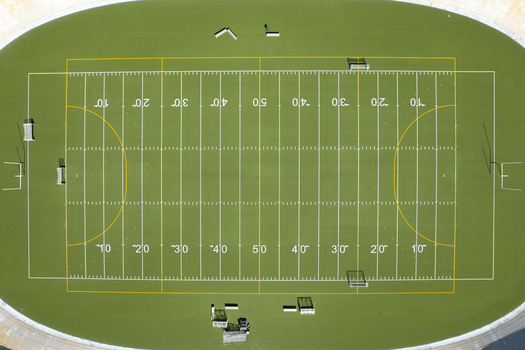 Aerial view of an American football field with green turf and white yard lines in Helsinki Uusimaa Finland.