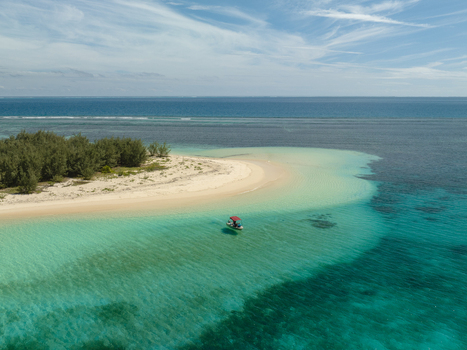 Aerial view of a pristine island with turquoise waters meeting the shore Noumea New Caledonia. Aerial view of a pristine island with turquoise waters meeting the shore Noumea New Caledonia.