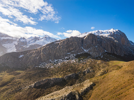 Aerial view of the rugged snow capped peaks and rocky slopes of Aladaglar National Park in Demirkazik Nigde Turkiye. Aerial view of the rugged snow capped peaks and rocky slopes of Aladaglar National Park in Demirkazik Nigde Turkiye.
