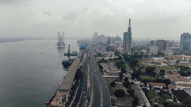 Aerial view of Lagos Island featuring the coastal highway urban skyline and nearby industrial structures along the water in Lagos Lagos Nigeria. Aerial view of Lagos Island featuring the coastal highway urban skyline and nearby industrial structures along the water in Lagos Lagos Nigeria.