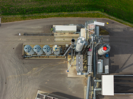 Aerial view of an industrial asphalt plant with metal silos and machinery in Hrusky South Moravian Region Czechia. Aerial view of an industrial asphalt plant with metal silos and machinery in Hrusky South Moravian Region Czechia.