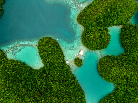 Aerial view of Sugba Lagoon with its turquoise waters surrounded by lush green islands wooden walkways and small boats in Del Carmen Caraga Philippines. Aerial view of Sugba Lagoon with its turquoise waters surrounded by lush green islands wooden walkways and small boats in Del Carmen Caraga Philippines.