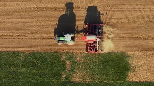 Aerial view of a tractor seeding a field Czechia. Aerial view of a tractor seeding a field Czechia.