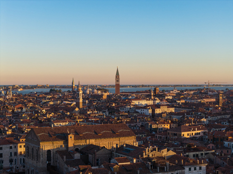 Aerial view of the historic city of Venice with its iconic bell tower terracotta rooftops and canals stretching towards the lagoon in Venice Veneto Italy. Aerial view of the historic city of Venice with its iconic bell tower terracotta rooftops and canals stretching towards the lagoon in Venice Veneto Italy.